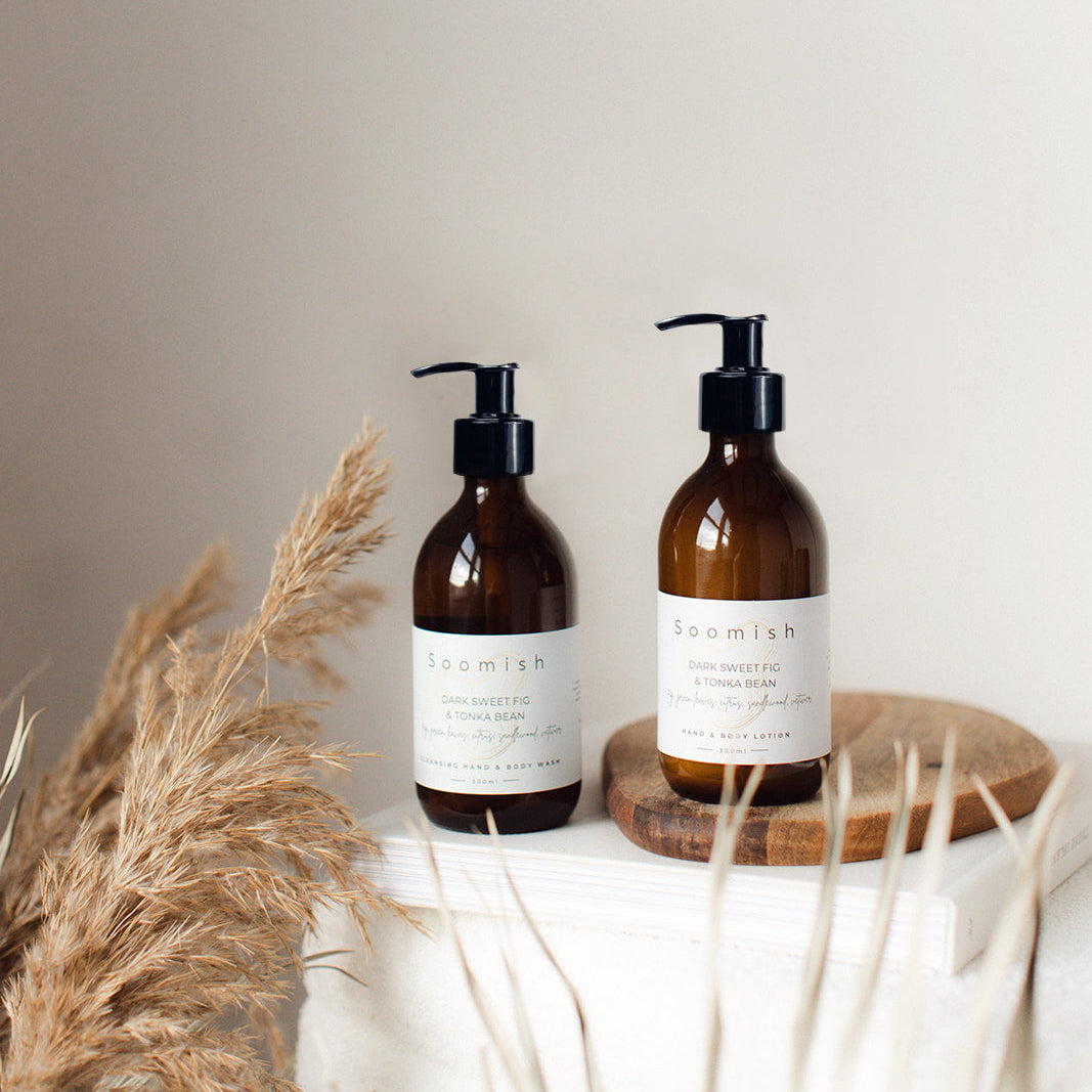 Two Soomish glass bottles with pump dispensers. 